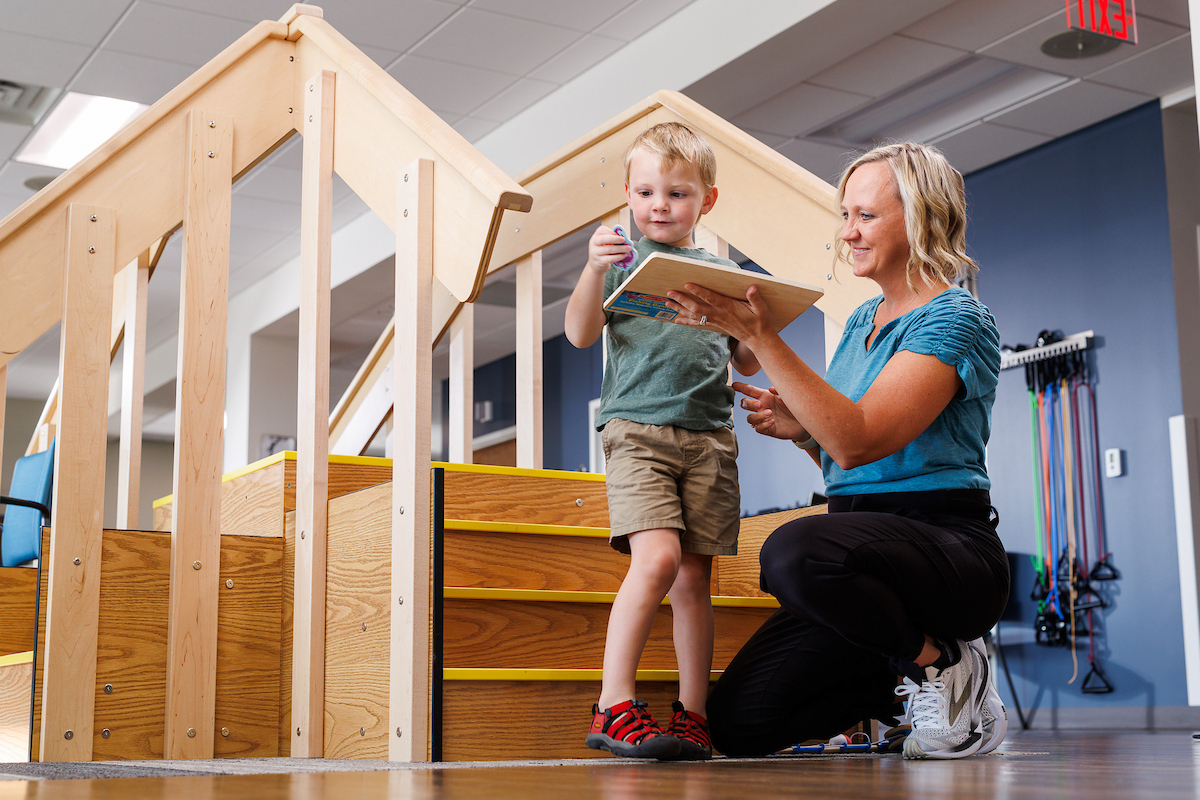 Physical Therapist working with child