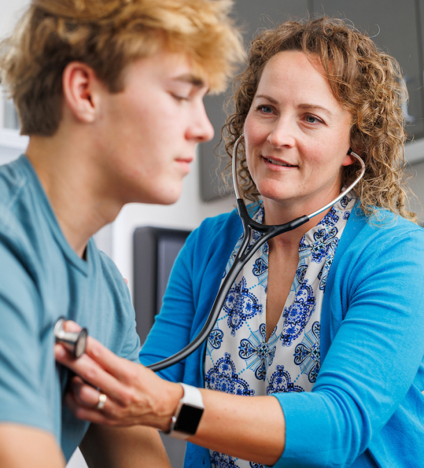 Nurse working with adolescent patient 