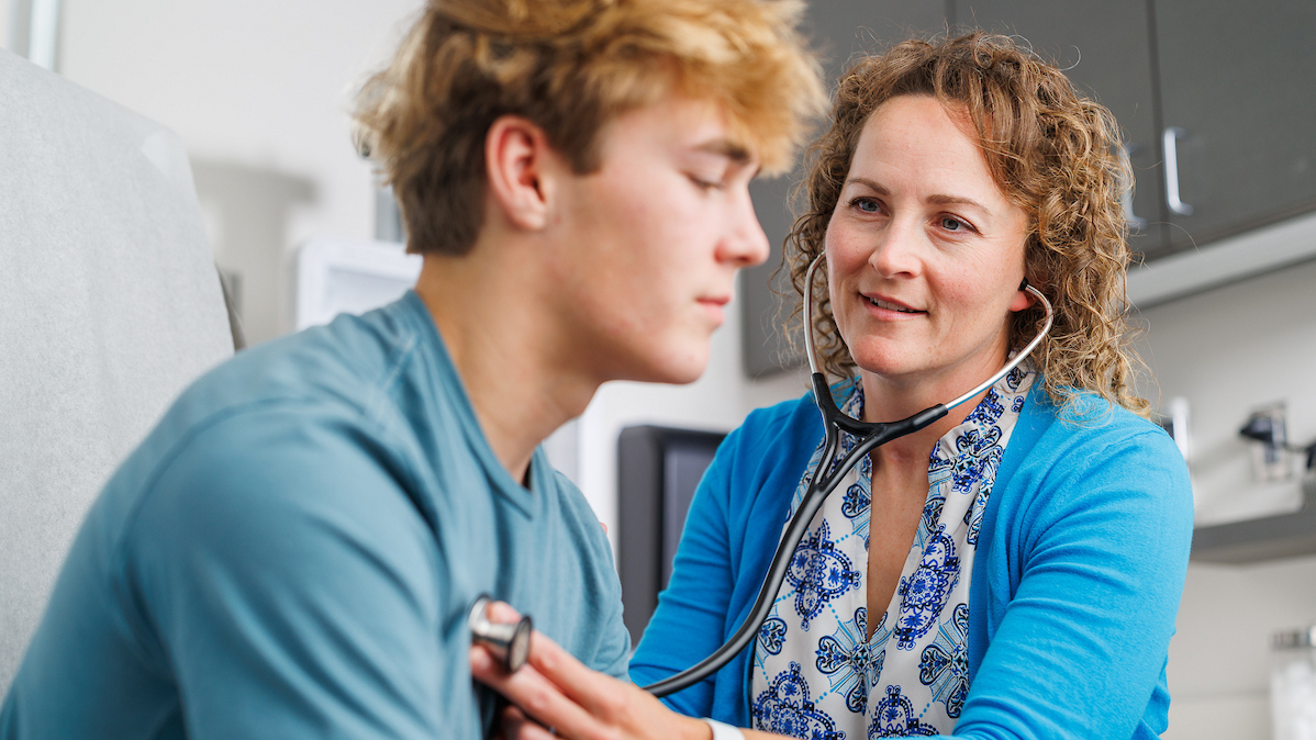 Nurse working with adolescent patient 