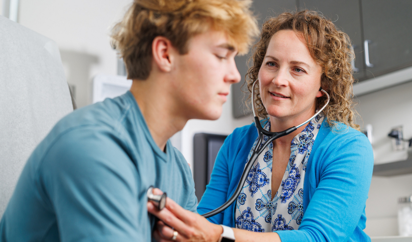 Nurse working with adolescent patient 
